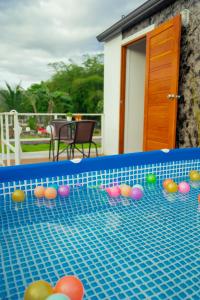 a pool with colorful balls on the top of it at Cana Garden 3 in Ban Khok