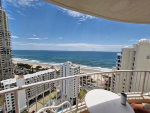 a balcony with a view of the beach and buildings at APR Private SUITES MOROC by the Beach in Gold Coast