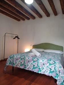 a bedroom with a bed with a floral comforter at La Bella Venezia - ENTIRE PRIVATE APARTMENT in Venice