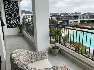 a balcony with a rattan chair and a view of the ocean at The Blyde Stylish Homes in Pretoria
