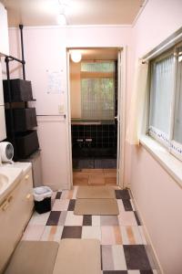 a bathroom with a checkered floor and a window at HAKONE LEON in Hakone