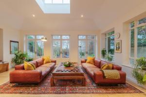 Sala de estar con 2 sofás y mesa de centro en Stunning 6-bedroom countryside home, en Reading