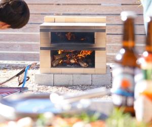 a fireplace with food cooking inside of it at 淡島シーサイドコテージ in Anan