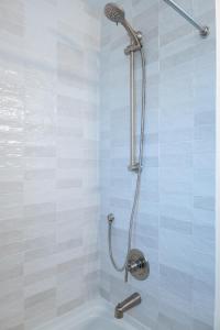 a shower with a shower head in a bathroom at Be A Nomad 2 br Close to the Beach in Jacksonville Beach