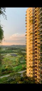 an aerial view of a tall building and a golf course at Sea view 2 bedroom Fully furnished Apartment Forest City Starview Bay Johor Malaysia in Kampong Pok Kechil