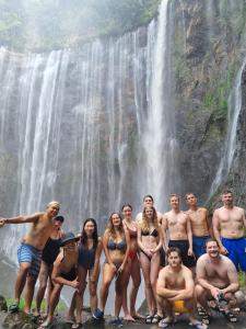 a group of people standing in front of a waterfall at Celebbest in Kuta