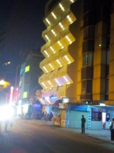 a building on a city street at night at Hotel Blue Star in Coimbatore