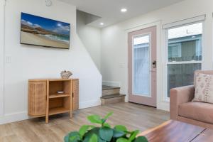 a living room with a chair and a table at Be A Nomad 2 br Close to the Beach in Jacksonville Beach
