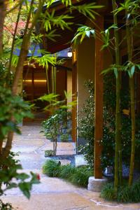 a building with a courtyard with trees and plants at tamao-たま靑- in Kyoto
