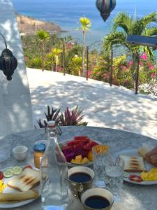 uma mesa com um prato de comida e uma garrafa em Villa Hopedome em Teluknarat