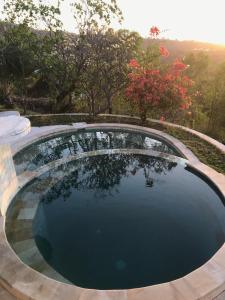 a swimming pool with a view of the trees at Villa Cocodome in Teluk Nara