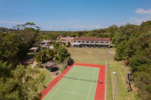 an aerial view of a tennis court in front of a house at Seaside Garden Hotel in Wamberal