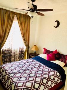 a bedroom with a bed and a ceiling fan at Flamingos in Ixtapa