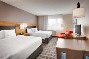 a hotel room with two beds and a desk at TownePlace Suites by Marriott Salt Lake City Downtown in Salt Lake City