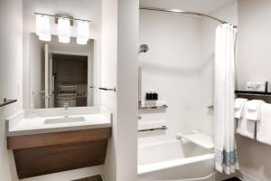 a bathroom with a sink and a tub and a shower at TownePlace Suites by Marriott Salt Lake City Downtown in Salt Lake City +22 photos
