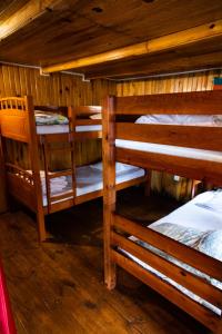 a room with two bunk beds in a cabin at les lys plaine des cafres in Le Tampon