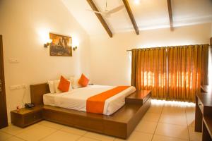 a bedroom with a bed in a room with a window at YELLOW LAKE RESORTS & SPA, Yercaud in Yercaud