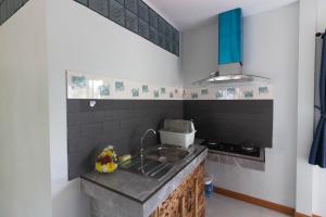 a kitchen with a sink and a counter top at BanrabianglayLangsuan in Ban Hin Sam Kon