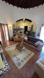 a living room with a couch and a table at Beach Villa in Saint Epiktitos