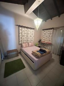 a bedroom with a large bed and a green rug at Beach Villa in Saint Epiktitos +95 photos