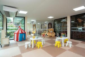 a toy room with tables and a teddy bear at Koh Chang Paradise Resort & Spa in Ko Chang