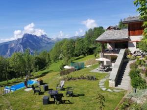a house on a hill with a swimming pool at appartement en chalet individuel sauna piscine in Valmeinier