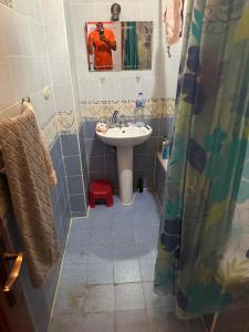 a bathroom with a sink and a shower curtain at Morning Star Guesthouse in Sharm El Sheikh
