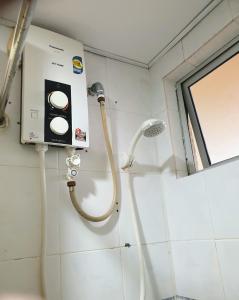 a shower in a bathroom with a shower at 99 Glory Beach Resort - seaview, poolview, beachfront,wifi in Seremban