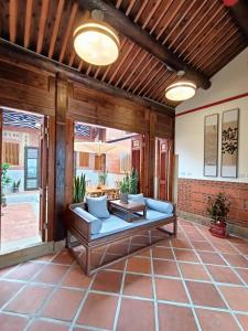 a patio with a blue couch and a table at Ba Ba Guan Hai Ancient House B&B in Jinsha