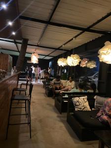 a group of people sitting at a bar in a restaurant at Bibhitaki Hostels Palolem Beach in Palolem