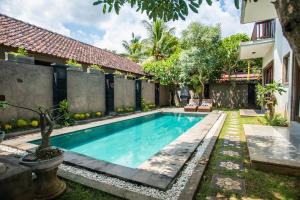 a swimming pool in the backyard of a house at Azure House - the dive to bright holiday in Ubud