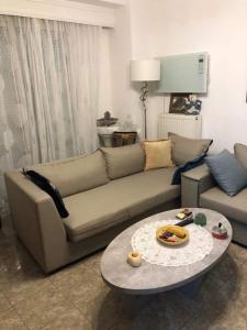 a living room with a couch and a table at Viki’s Appartement near ktel Serron in Serres