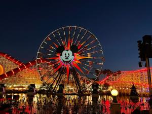 a ferris wheel with a face on it at night at MAGICAL Xcape, POOLS-SPA, WALK 2 DISNEY, CENTRAL AC-HEAT, FULLY EQUIPPED, 2 FREE PARKING SPACES, OWNER MGMT in Anaheim