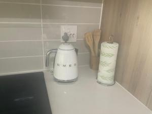 a kitchen counter with a blender and a roll of paper towels at Contemporary unit at the Blyde in Pretoria