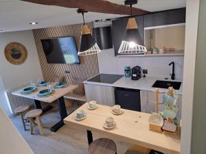 een keuken met een houten tafel en een tafel en een keuken met een aanrecht bij LA CASETA DELS HEROIS in Puigcerdà