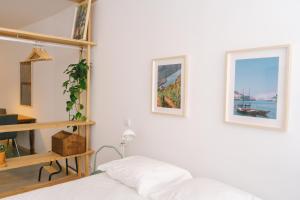 a bedroom with a bed and two pictures on the wall at Porto Serenity loft. in Porto
