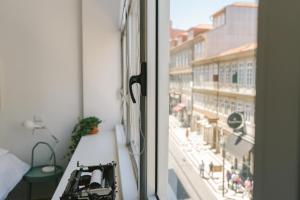 a room with a window with a view of a city at Porto Serenity loft. in Porto