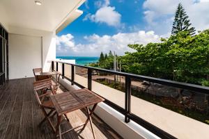 a balcony with two chairs and a view of the ocean at Ocean Paradise in Yanliau