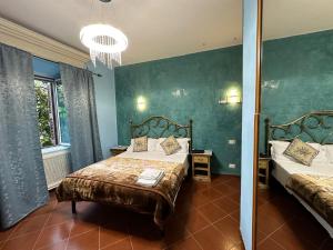 a bedroom with two beds and a chandelier at Signor Suite Colosseo in Rome