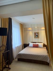 a bedroom with a bed and a large window at Візит in Bila Tserkva