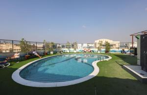 a large swimming pool on top of a building at Aavri Hotel in Dubai