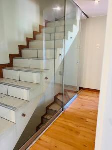 a staircase in a room with a glass wall at Hermosa Casa completa en Arequipa 