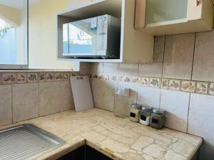 a kitchen with a counter top with a small refrigerator at Hermosa Casa completa en Arequipa 