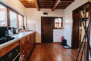 a kitchen with wooden floors and a wooden door at Little Bear Lodge in Sibiu
