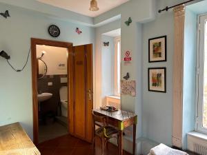 a bathroom with a table and a toilet and a sink at Signor Suite Colosseo in Rome