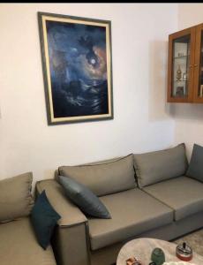 a living room with a couch and a painting on the wall at Viki’s Appartement near ktel Serron in Serres