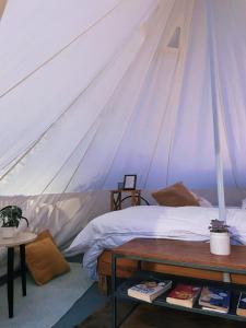a bedroom with a bed in a tent at Bell Glamping - Luxury Bath in Mukteshwar's Nature in Mukteswar