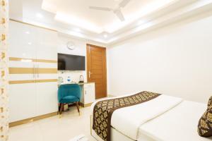 a hotel room with a bed and a desk at Hotel Krish - Near Medanta and Fortis Hospital Gurugram in Gurgaon