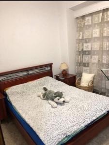 a teddy bear laying on top of a bed at Viki’s Appartement near ktel Serron in Serres