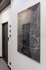 a poster of a subway map on a wall in a hallway at Apartamenty Plebańska-Rynek in Gliwice
